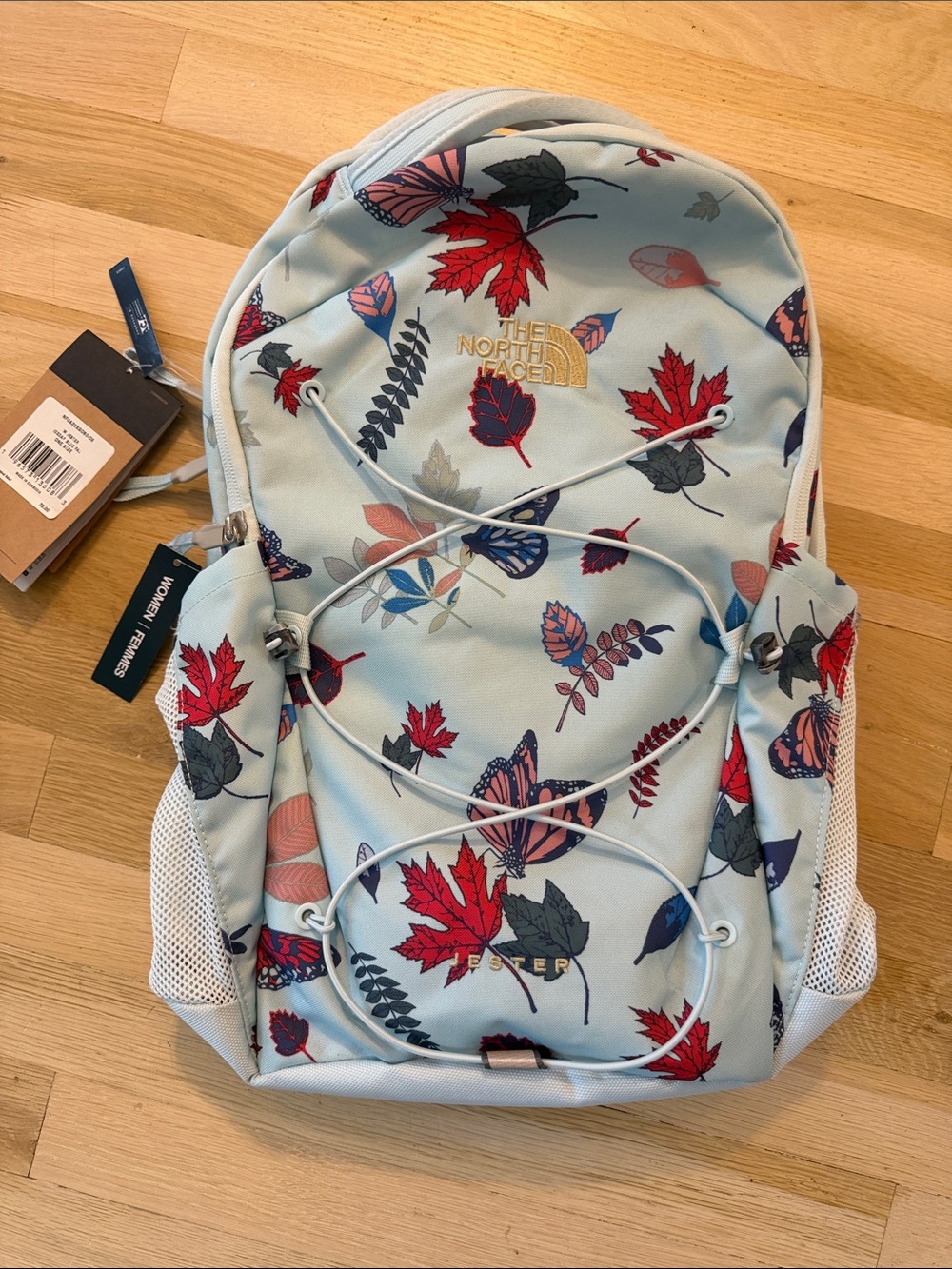 The North Face Women's Light Blue Backpack with Leaf & Butterfly Accents